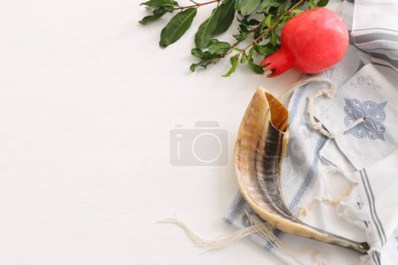 Photo for Religion image of shofar (horn) and pomegranate on white prayer talit. Rosh hashanah (jewish New Year holiday), Shabbat and Yom kippur concept - Royalty Free Image