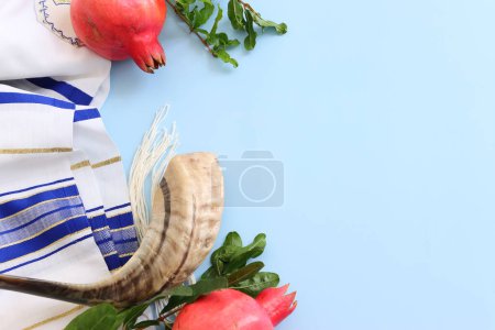 Photo for Religion image of shofar (horn) and pomegranate on white prayer talit. Rosh hashanah (jewish New Year holiday), Shabbat and Yom kippur concept - Royalty Free Image