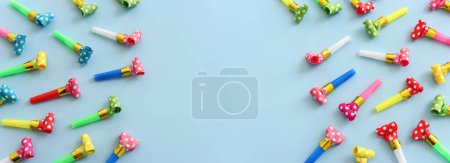 Photo for Collection of colorful party blowers on blue background. Concept of party or celebration - Royalty Free Image