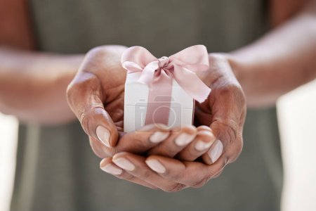 Photo for Small gift in the hands of an african american woman. Closeup of african woman holding little box in hands. Small white present in the hands of a black lady. - Royalty Free Image