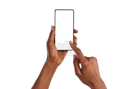Photo for Close up of african american woman hands showing smartphone against white background. Black woman hands touching blank empty screen of cellphone. Close up of female hands using app on mobile phone isolated. - Royalty Free Image
