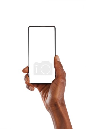 Photo for Close up of female african hand showing smartphone against white background. African american woman hand holding cellphone with blank screen. Closeup of black hand holding smartphone with empty screen isolated on white background. - Royalty Free Image