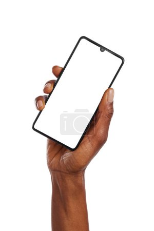 Photo for Close up of black woman hand holding smartphone against white background. African american woman hand holding cellphone while showing empty screen isolated. Closeup of female raising up hand while holding cell phone vertically with blank screen ready - Royalty Free Image