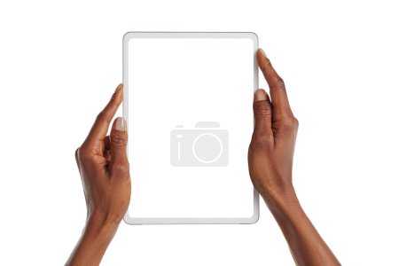 Photo for Close up african american woman hands showing digital tablet against white background. Female black hands holding digital tablet vertically with empty screen isolated. Girl holding modern digital device with blank screen. - Royalty Free Image