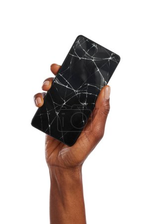 Photo for Close up of black woman hand holding broken smartphone against white background. African american woman hand holding cellphone with broken screen. Broken screen glass of a modern phone, need repair. - Royalty Free Image
