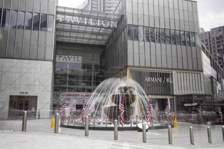 Photo for Kuala Lumpur, Malaysia - August 21, 2022: Long Exposure image of the Pavilion Crystal Fountain in front of Pavilion shopping mall in the city center of KL. Malaysian flag around the water fountain - Royalty Free Image