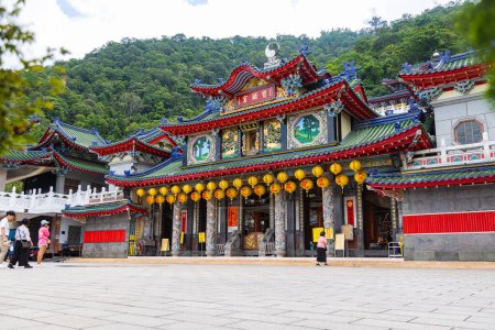 Photo for Puli, Taiwan - May 26, 2023: Inside the Baohu Temple of Dimu. Architectural marvel with vibrant red pillars, golden details. Taiwanese people donate and praying in the Temple. Buddhist religion - Royalty Free Image