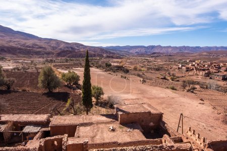 Hiking trail through idyllic beautiful lonely old clay house berber villages in high Atlas mountains valley in Morocco