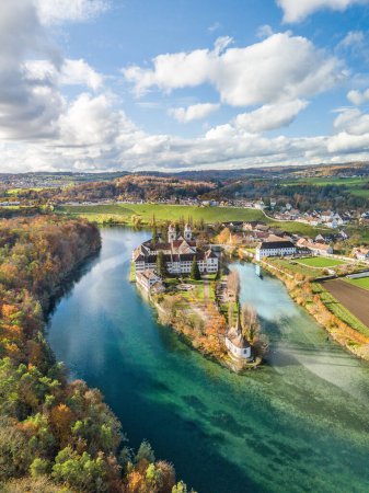 Photo for Aerial view of the Rheinau Abbey Islet on Rhine river in autumnal splendid colors, Switzerland - Royalty Free Image