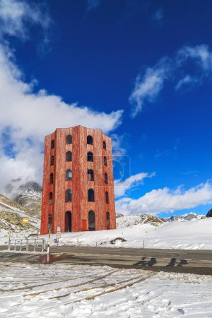 Photo for Grisons, Switzerland - March 12. 2023:The red Julier Theater Tower on the Julier Pass (2284 m above sea level) in winter. Canton of Graubuenden, Switzerland. - Royalty Free Image