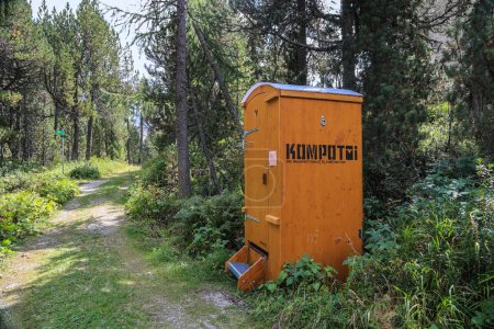 Photo for Maloja, Switzerland - August 25. 2023: Mobile compost toilet at a hiking roadside. (Words in German: Compost Toilet to rent). The eco friendly toilet uses sawdust to cover human excrement for cycling. - Royalty Free Image