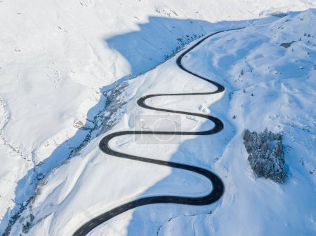 Photo for Aerial view of the winding road over the  Julier Pass in Swiss Alps mountain in winter full of snow, Canton Grison, Switzerland - Royalty Free Image