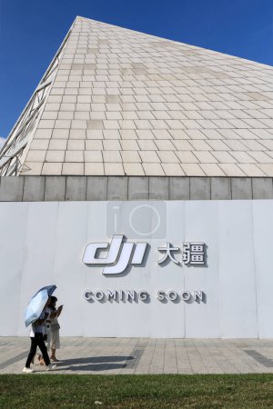 Photo for Shenzhen, China - November 05.2023: The coming event announcement on the DJI flagship shop wall for new product. DJI is a giant drone manufacturer in China, presenting new series every year. - Royalty Free Image