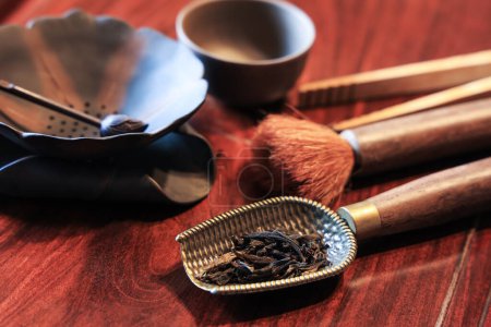 Photo for Closeup of oriental tea making ceremony tools: tea spoon, tea brush, tea twezzers, tea cup, tea drippers on a wooden table - Royalty Free Image