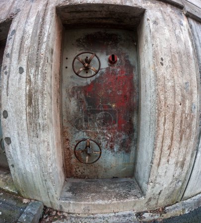 Closeup of a weathered door leading to a air raid shelter in Stockholm, Sweden.