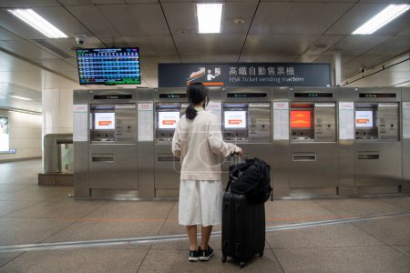 Photo for Taipei, Taiwan- 5 Dec, 2022: Passenger stands in front of Taiwan High Speed Rail ticket vending machine at Taipei railway train station. - Royalty Free Image