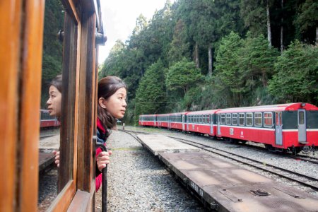Photo for Alishan, Taiwan- 7 Dec, 2022: Tourist enjoys the beauty of Alishan National Park with the scenic view and iconic red train. - Royalty Free Image