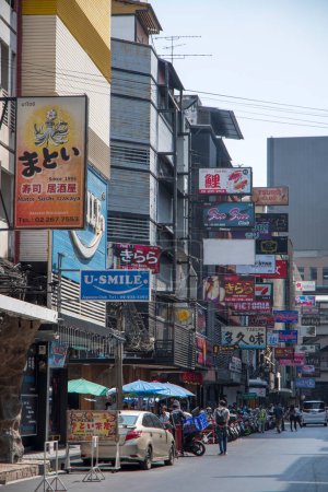 Foto de Bangkok, Thailand- 15 Feb, 2023: Various billboards display on the shop along Silom area, Bangkok. Silom area nightlife is most famous for its red light district of Patpong - Imagen libre de derechos