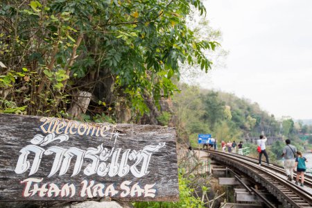 Photo for Kanchanaburi, Thailand- 16 Feb, 2023: Tourists walk along the Tham Krasae Railway Bridge, Kanchanaburi. It was built over during World-war II of only 17 days during the spring of 1943. - Royalty Free Image
