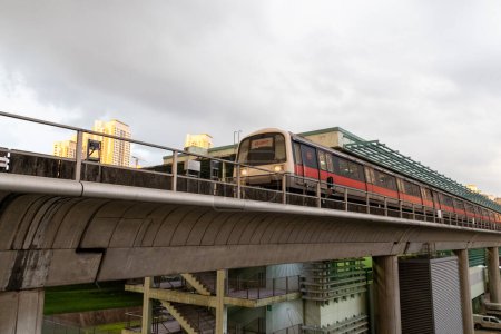 Photo for Singapore- 2 Feb, 2024: MRT train is travel on the housing area in Singapore. MRT train is the most important public transport is Singapore - Royalty Free Image