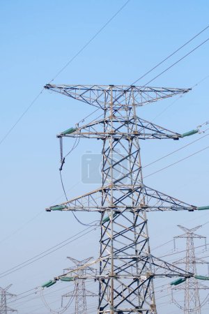 Electric line power tower on background blue sky