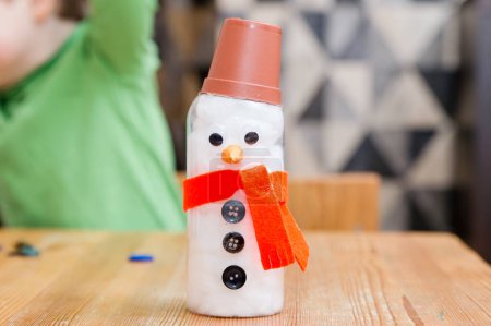Make a Snowman. Christmas time is here. Excitement and fun advent activities at home when waiting for the holidays. Family creative workshop. 5 minute craft for pre-school and primary school children.