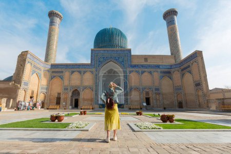 happy tourist with hat looking Gur-E Amir Mausoleum, the tomb of the Asian conqueror Tamerlane or Timur, in Samarkand, Uzbekistan