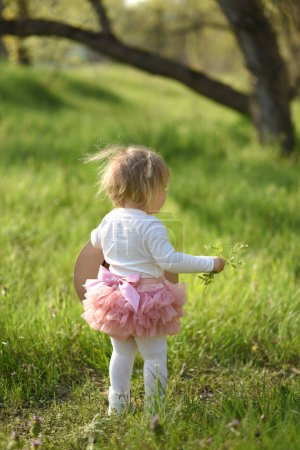 Photo for Portrait of a cute little girl in spring meadow on green grass - Royalty Free Image