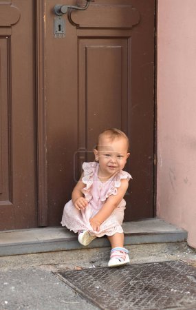 Photo for Little girl in the street of beautiful old town - Royalty Free Image