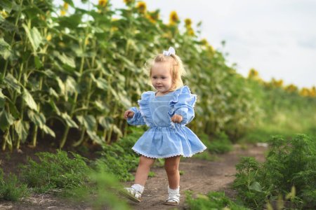 Photo for Little beautiful girl in a field of sunflowers. Child in a summer field - Royalty Free Image