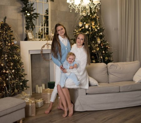 Photo for My Real Holiday. My family celebrates kinship. Christmas in the family. Mom and two daughters - Royalty Free Image