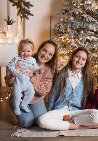 Photo for My Real Holiday. My family celebrates kinship. Christmas in the family. Mom and two daughters - Royalty Free Image