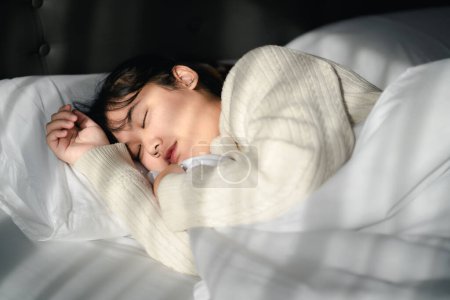 Photo for Young woman sleeping on white bed. - Royalty Free Image