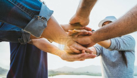 Photo for People putting their hands together. Friends with a stack of hands showing unity and teamwork. Friendship happiness leisure partnership team concept. - Royalty Free Image