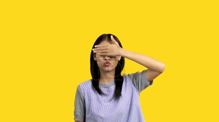 Photo for Asian women covering their eyes with their hands means not acknowledging or pretending not to see, Use your second hand to cover your eyes, Fear of socializing, I don't want to know the stories. - Royalty Free Image