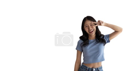 Photo for Young Asian woman making two thumbs up gesture showing joy and fun, Symbol of good friendship, Popular photo poses, Make a v-shaped finger, White background. - Royalty Free Image