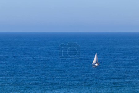 Photo for Small Cabin Yacht On Open Blue Ocean - Royalty Free Image