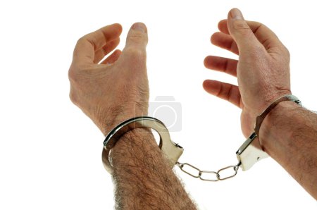 Téléchargez les photos : Justice concept with handcuffed hands close up on white background - en image libre de droit