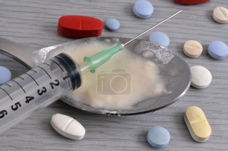 Addiction concept with various psychoactive substances and a syringe