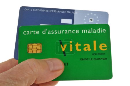 Photo for Vitale card and European health insurance card held in hand close up on white background - Royalty Free Image