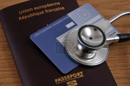 Photo for European health insurance card and stethoscope lying on a European Union passport close up - Royalty Free Image