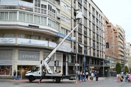 Photo for Bucket truck on a street in Alicante to repair a streetlight in the city - Royalty Free Image