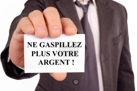 Foto de Empresario sosteniendo una tarjeta que dice en francés dejar de gastar su dinero - Imagen libre de derechos