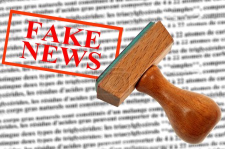 Photo for Fake news concept with an ink stamp and blurred text - Royalty Free Image