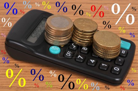 Photo for Business concept with stacks of Euro coins lying on a calculator surrounded by percentage signs - Royalty Free Image
