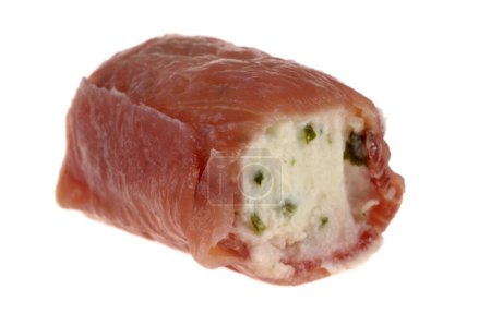 Mini smoked speck roll stuffed with herb ricotta close-up on white background