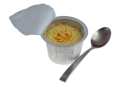 Aluminum pot of open industrial rice pudding seen from above with a spoon on white background