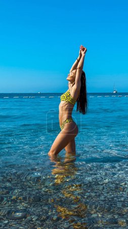 Photo for Beautiful woman in bikini on tropical beach. Portrait of charming young woman at sea. Brunette tanned lady in swimwear enjoying summer time - Royalty Free Image