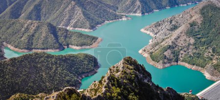 Blue green Kozjak lake surrounded by hills in the mountains of Macedonia. Large artificial lake. Breathtaking panoramic view.