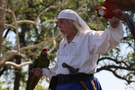 Photo for 4-15-2023: Visalia, California: People in period costumes doing a parrot show at a Renaissance Faire - Royalty Free Image